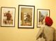 A visitor at the inauguration of the exhibition "A Farewell to Arms" on 20 September 2009 in New Delhi looks at pictures - left to right - from Adrian Fisk (taken in Chhattisgarh), Raghu Rai (taken in Manipur) and Jitender Gupta (taken in Madhya Pradesh)